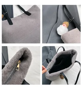 Detailed view of grey plush tote bag, faux fur texture, black straps and cute doll pendant.