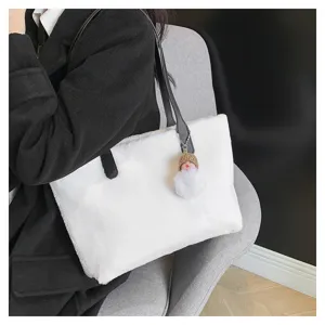 Close-up detail of the fluffy white plush shoulder bag with cute furry doll pendant, soft texture.
