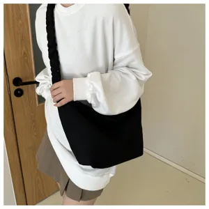 Black canvas shoulder bag, large capacity casual crossbody tote bag with braided strap detail.