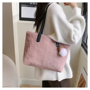 Stylish plush shoulder bag for women, cozy winter tote bag with fluffy keychain detail.