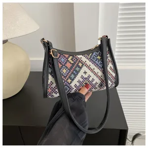 Ethnic woven shoulder bag detail showcasing the textured fabric and chic crescent hobo design.