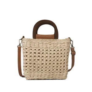 Stylish woven straw bucket bag with a brown wooden top handle and convenient shoulder straps.