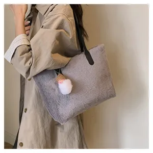 Close-up detail of the cozy gray plush shoulder bag featuring soft fleece texture and cute charm.
