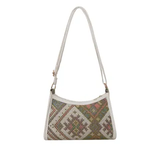 Detailed view of the ethnic style woven underarm shoulder bag with white leather trim.