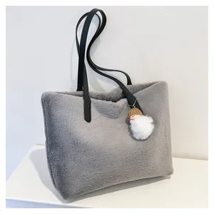 Stylish grey faux fur shoulder bag, fluffy winter tote handbag with leather handles.