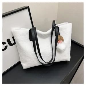 White plush tote bag for women with black leather handles and cute doll pendant, soft winter handbag.