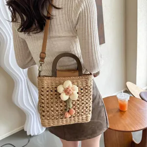 Stylish women woven straw bucket bag with wooden handle and cute floral decor casual handbag