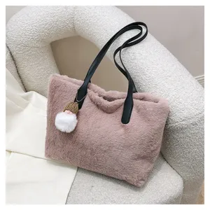 Close-up detail of fluffy plush shoulder bag with black handles and cozy winter design.