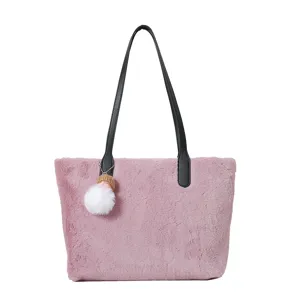 Plush shoulder bag detail showing soft mauve faux fur texture and black leather handle.