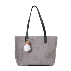 Grey plush shoulder bag detail, soft lamb wool fabric and black leather handle features.