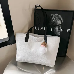 Stylish white fluffy tote bag for women, cozy winter sherpa shoulder handbag with charm.