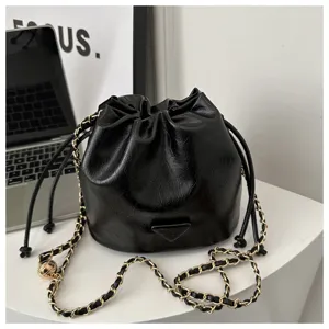 Black leather bucket bag with chain strap, stylish shoulder bag for women daily detail view.