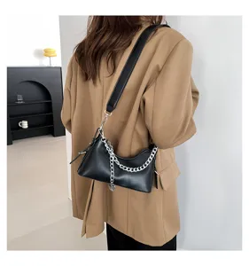 Chic black underarm shoulder bag detail showing silver chain strap and premium PU leather finish.