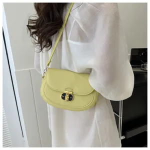 Stylish yellow shoulder bag for women, featuring a chic lock closure and elegant design.