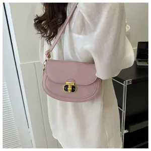 Women's chic pink saddle shoulder bag with elegant lock closure, perfect daily crossbody.