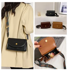 Detailed view of womens fashion crossbody bag with wide strap, trendy small shoulder bag.