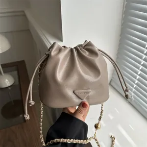Stylish khaki bucket bag with chain strap and drawstring closure for women daily wear.