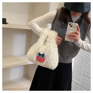 Detailed view of the cute plush monster handbag, showing soft furry texture and cartoon face.