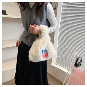 Cute plush handbag with cartoon monster design, fluffy white shoulder bag for girls.