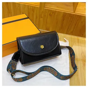 Black crossbody bag for women, trendy small square handbag with stylish wide patterned strap.