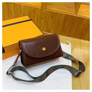 Trendy brown PU leather shoulder crossbody bag with wide patterned strap and chic flower clasp.
