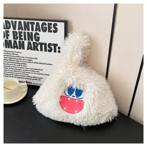 Cute cartoon monster plush handbag, soft fluffy texture with funny face embroidery detail.