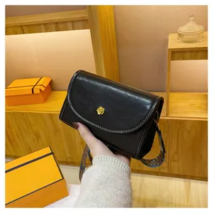 Stylish black leather shoulder bag with chic flower clasp and wide strap for women