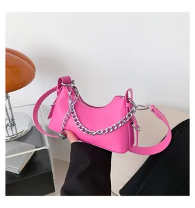 Pink hobo shoulder bag with silver chain, stylish crescent crossbody purse for women.