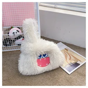 Cute monster plush handbag detail showing soft white fluffy texture and funny cartoon face embroidery.