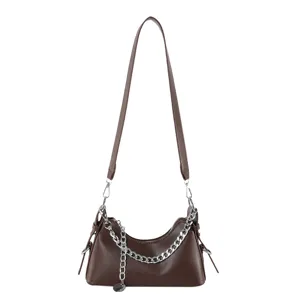 Detailed view of the stylish brown underarm shoulder bag featuring a chic silver chain.
