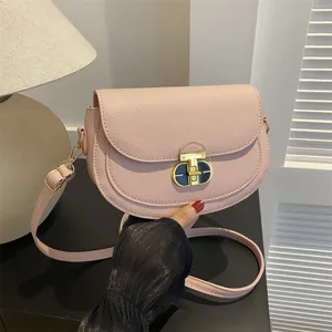 Stylish pink leather saddle bag for women, chic crossbody shoulder bag with metal lock.
