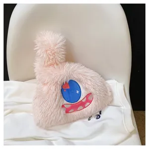 Close-up of the pink monster plush bag, showing fluffy faux fur and embroidered eye details.