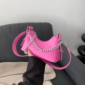 Trendy pink underarm shoulder bag for women with stylish silver chain and handle design.