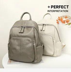 Detailed view of the soft leather backpack showing fine texture, zipper pockets and handle.