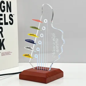 Wooden luminous guitar pick display stand with colorful picks and acrylic headstock holder.