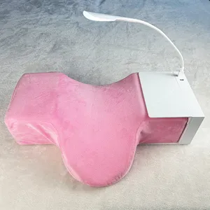 Pink eyelash extension memory foam neck pillow with tool tray and LED light for salon use.
