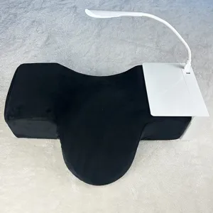 Ergonomic eyelash extension pillow detail, featuring comfortable memory foam and storage shelf.