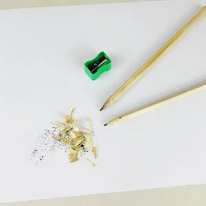 Hexagonal wooden pencils set with green sharpener top view product image for students and art.