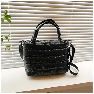 Stylish black quilted puffer tote bag with comfortable handles and shoulder strap for winter.