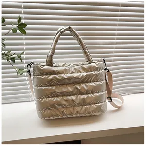 Detailed view of the stylish silver puffer tote bag, casual quilted crossbody shoulder bag.
