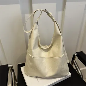 Minimalist off-white hobo shoulder bag for women, soft PU leather large capacity commuter bag.
