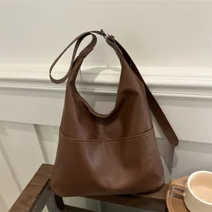 Stylish brown leather hobo shoulder bag for women, large capacity commuter tote for winter.