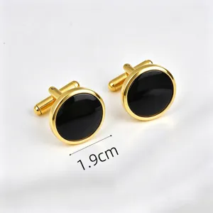 Gold-tone round cufflinks detail with black inlay and size marker 1.9cm for formal shirt wear.