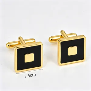 Elegant square cufflinks closeup featuring gold frame and black enamel. Formal accessory.