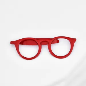 Red glasses shape tie clip detail, glossy finish metal lapel pin accessory, close-up shot view.
