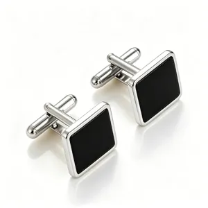 Close-up detail of classic square men cufflink in silver tone with black inlay finish.