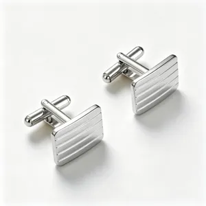 Close-up detail of silver-toned metallic cufflinks featuring a sleek striped rectangular face.