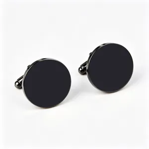 Close up detail view of sleek black round stainless steel cufflinks for men dress shirts.