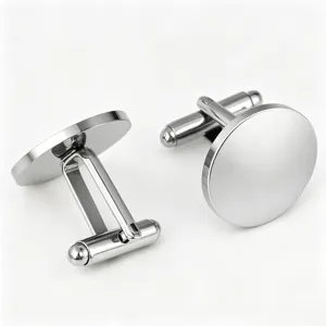 Detail view of polished silver-colored stainless steel round cufflinks, sleek and elegant.