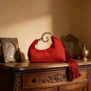 Red suede fringe handbag with gold spiral handle, vintage evening clutch, elegant niche design.